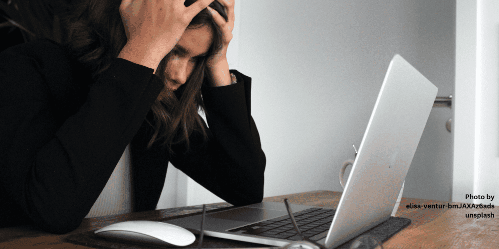 Office worker reacts in distress as they realise their email account has been hacked